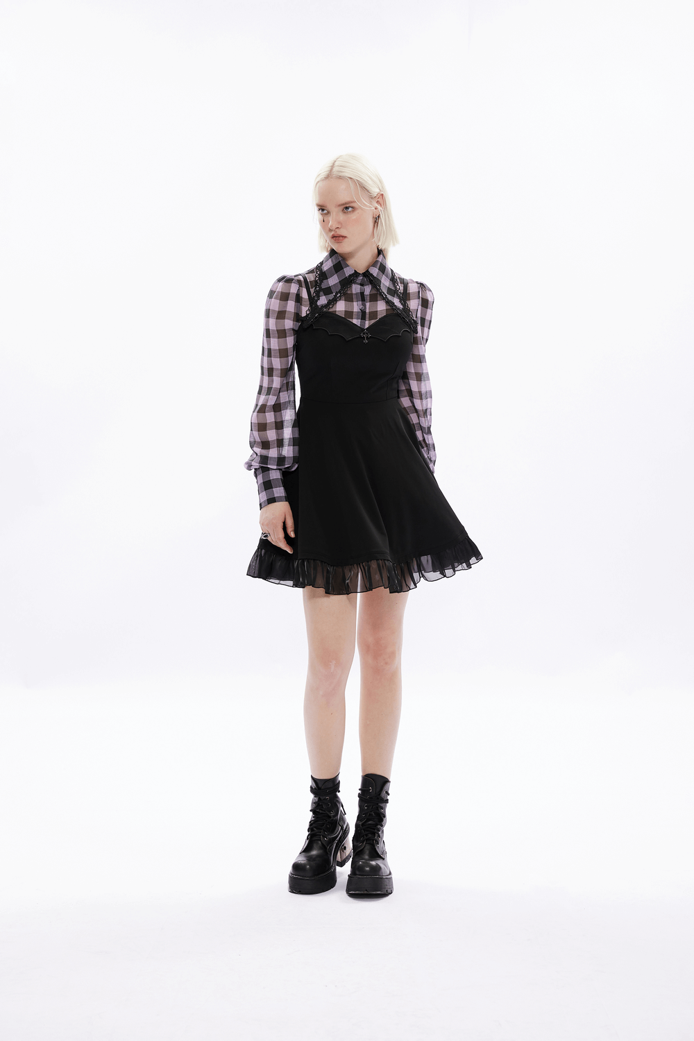 Gothic black scalloped skater dress with lace hem, paired with a plaid shirt, perfect for evening events.