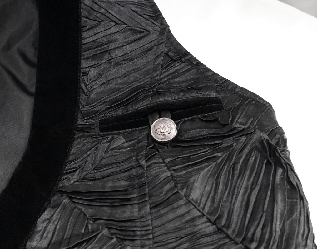 Gothic black men's waistcoat detail showcasing silver button and textured fabric design.
