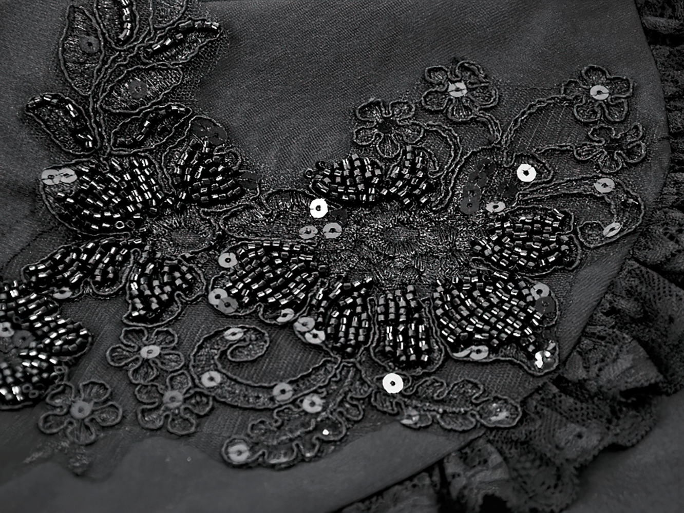 Gothic Black Shrug with Beaded Embroidery and Long Sleeves intricate beaded floral design in black fabric.