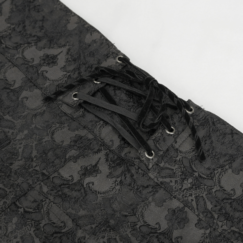 Close-up of black silk high waist trousers with elegant vintage lace-up detail for gothic fashion.