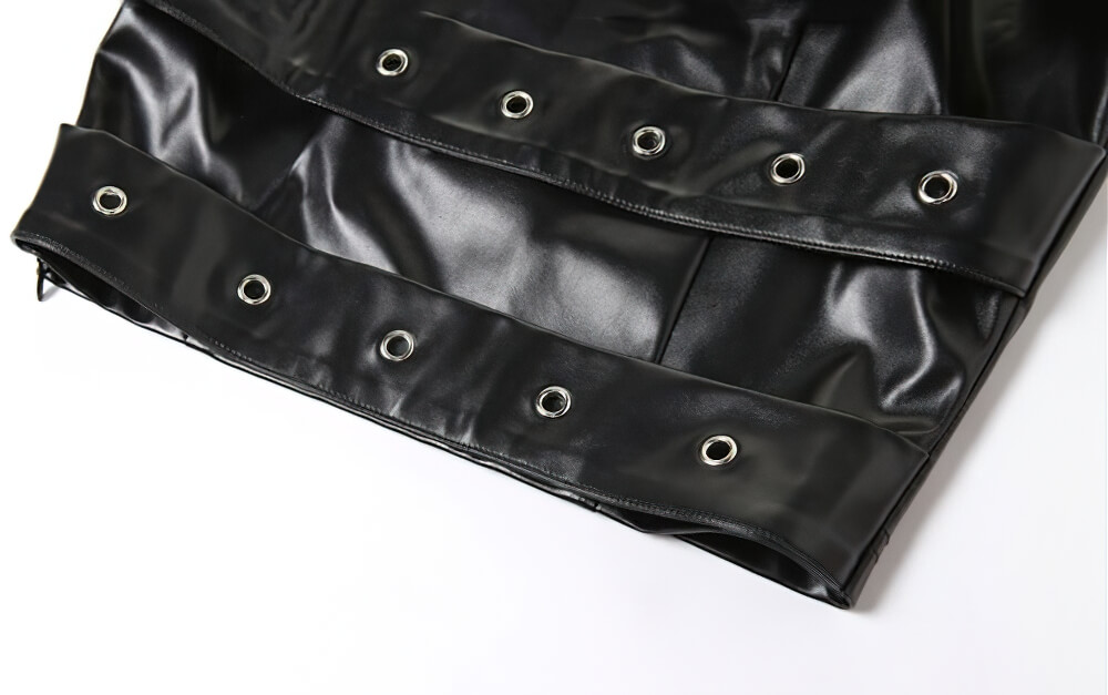 Close-up of gothic black strapless crop top featuring stylish belt and eyelet details for a bold fashion statement.