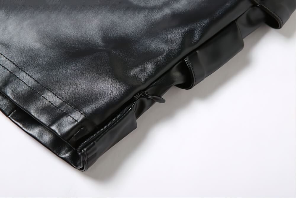 Close-up of gothic black strapless crop top zipper detail, showcasing stylish sleek fabric and design.