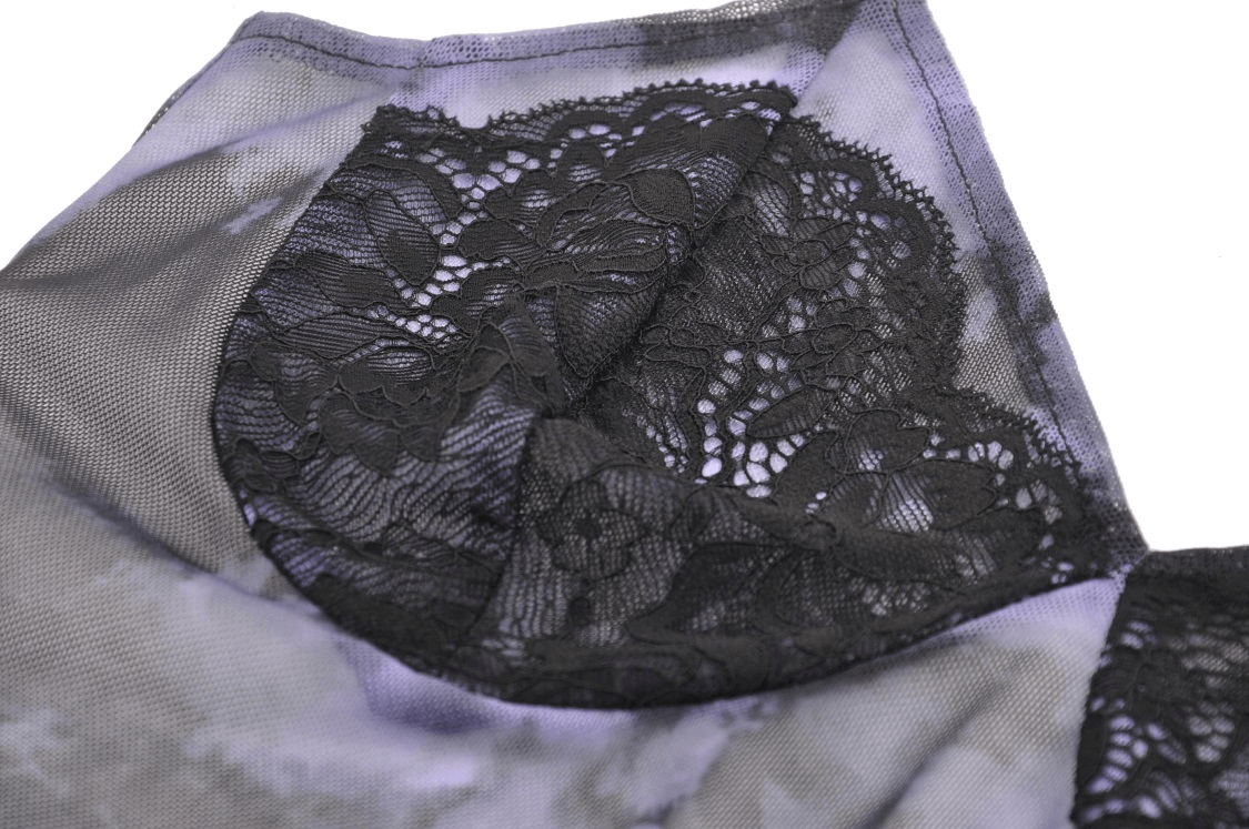 Close-up of gothic black lace trim on satin fabric, showcasing intricate detailing and elegant design.