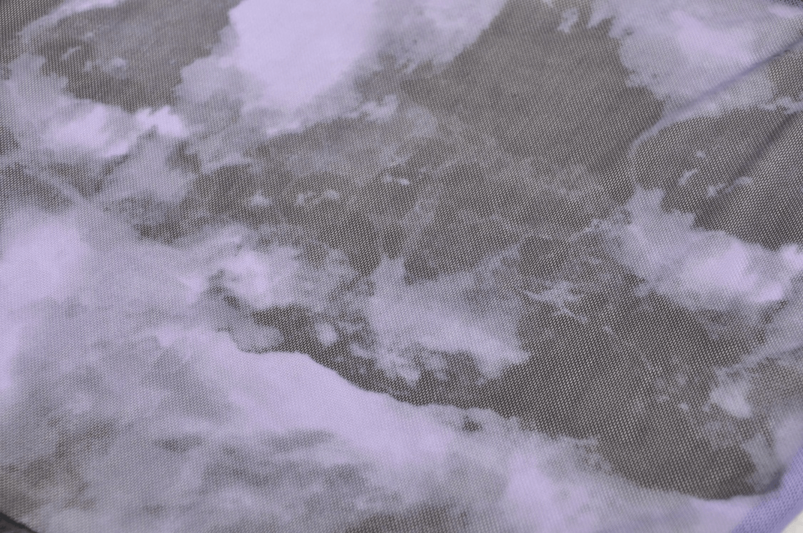 Close-up of soft fabric featuring a pastel cloud pattern, perfect for stylish and comfortable apparel.