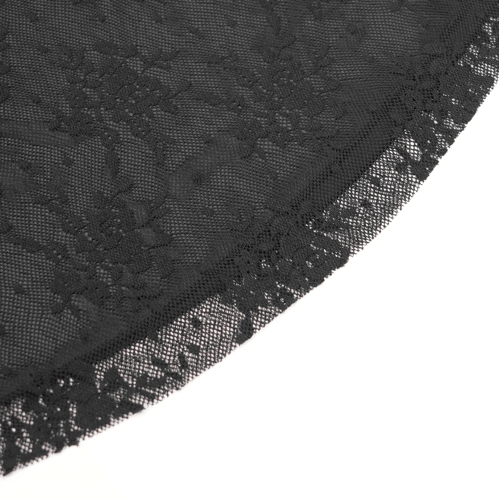 Close-up of intricate black lace fabric featuring floral patterns and delicate edges for gothic fashion.