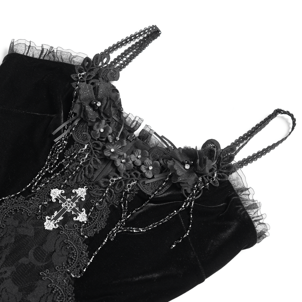 Close-up of gothic black velvet dress with lace and rose trim, featuring spaghetti straps and intricate floral details.