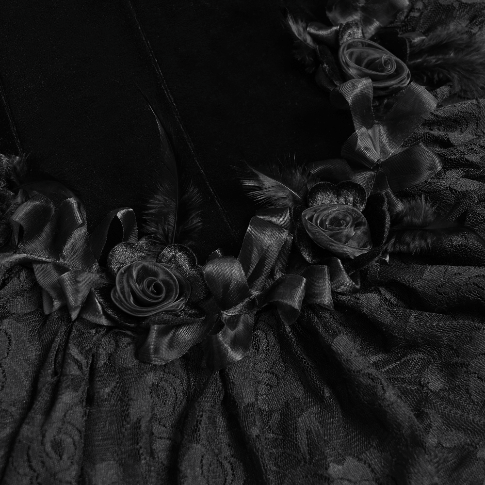 Close-up of gothic black velvet dress detail with lace, satin roses, and ruffled trim for a dramatic Victorian look.