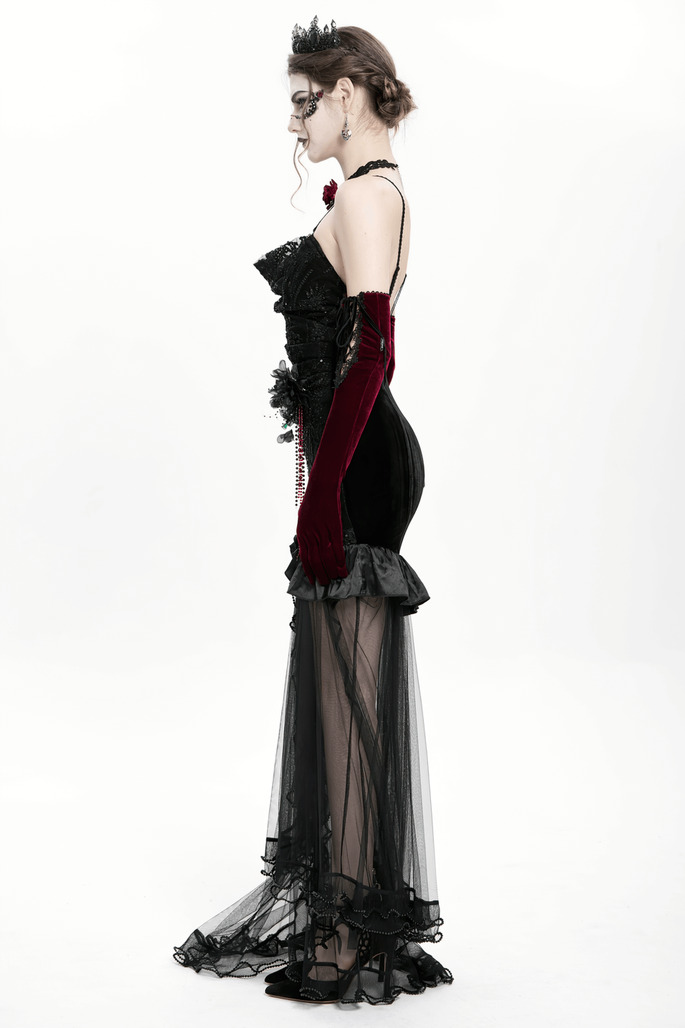 Elegant gothic black velvet high-low dress with sheer mesh train and ruffled satin hem, perfect for evening events.