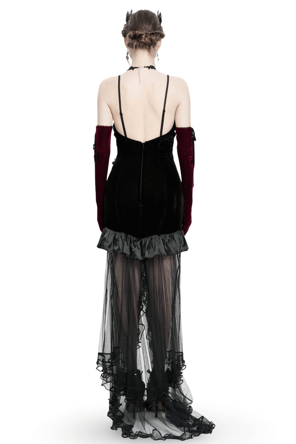 Back view of Gothic black velvet and sheer mesh high-low dress with ruffled satin hem and elegant spaghetti straps.