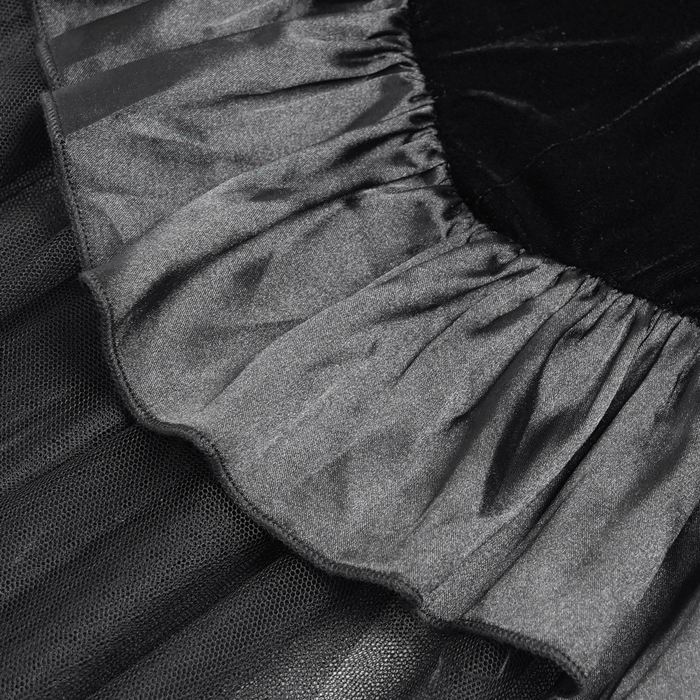Close-up of the ruffled satin hem and sheer mesh layers of a gothic high-low dress in black.