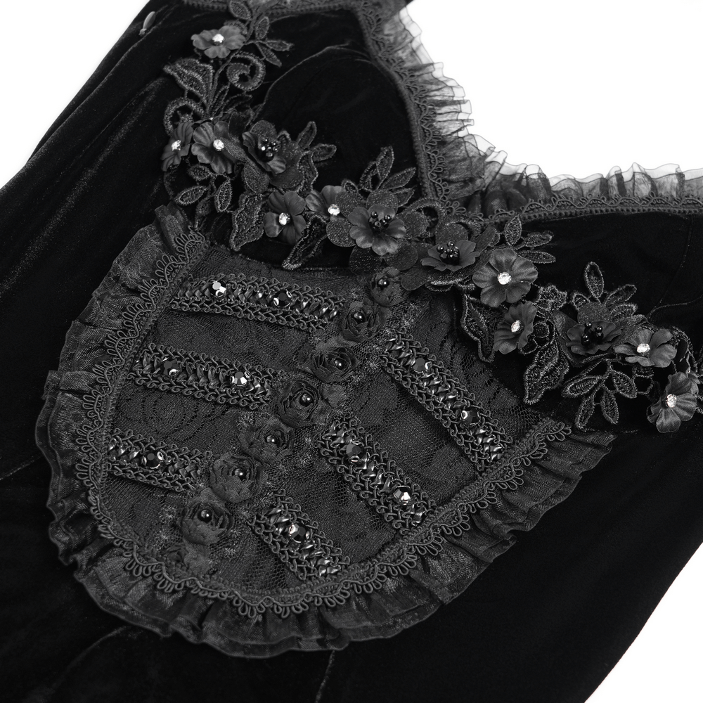 Close-up of gothic black velvet dress showing lace and floral appliqué details for a Victorian-inspired look.