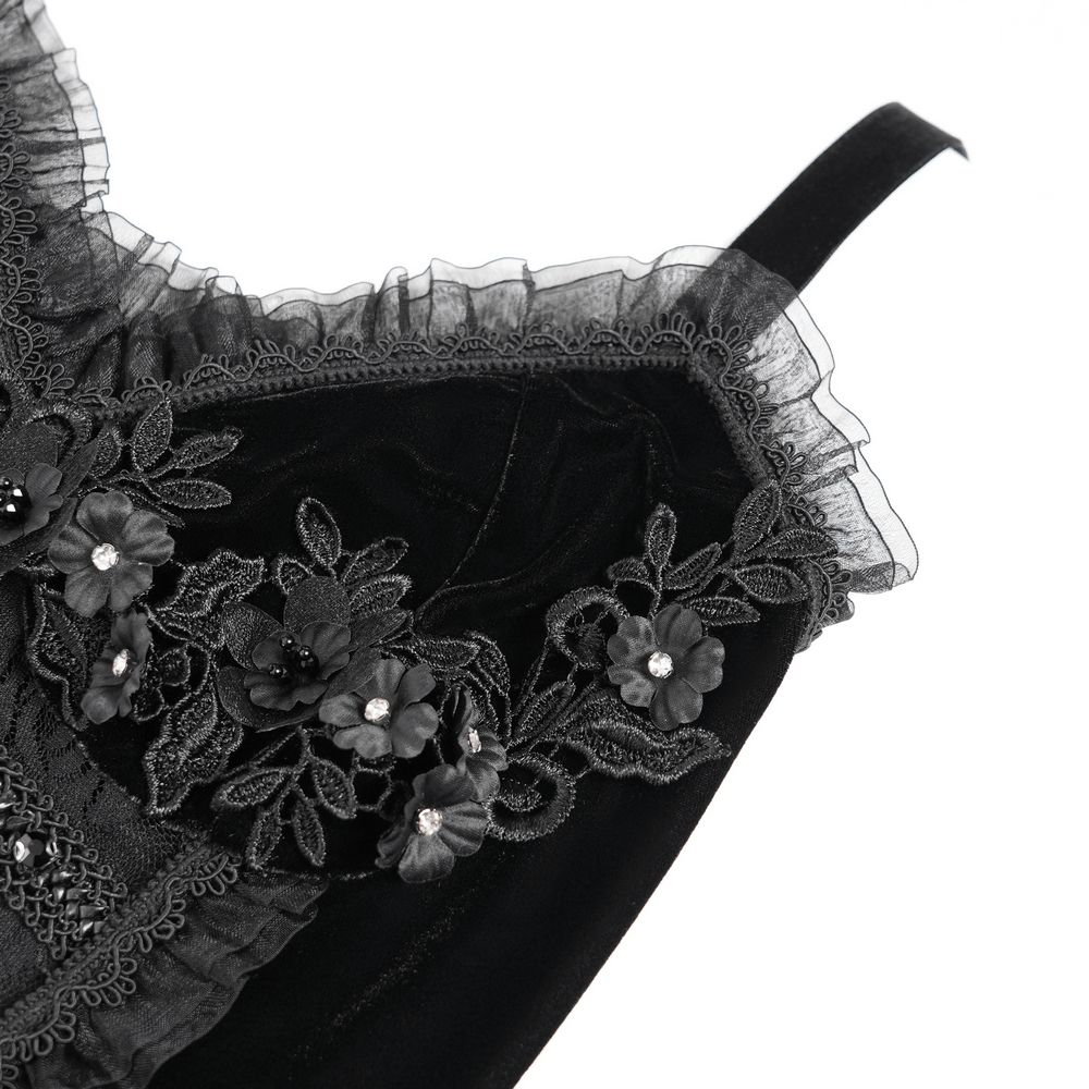 Gothic black velvet dress close-up featuring lace, floral appliqué, and ruffled neckline for Victorian elegance.