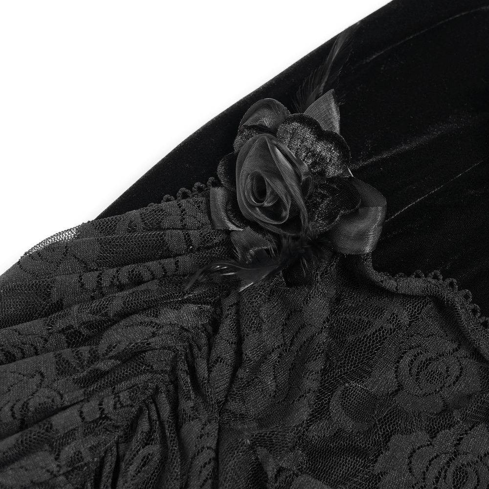 Close-up of gothic black velvet dress showing lace, fringe, and floral accents for a dramatic, Victorian-inspired look.