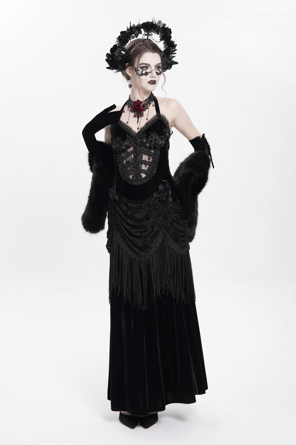 Gothic black velvet dress with lace and fringe, inspired by Victorian fashion, perfect for dark romantic events.