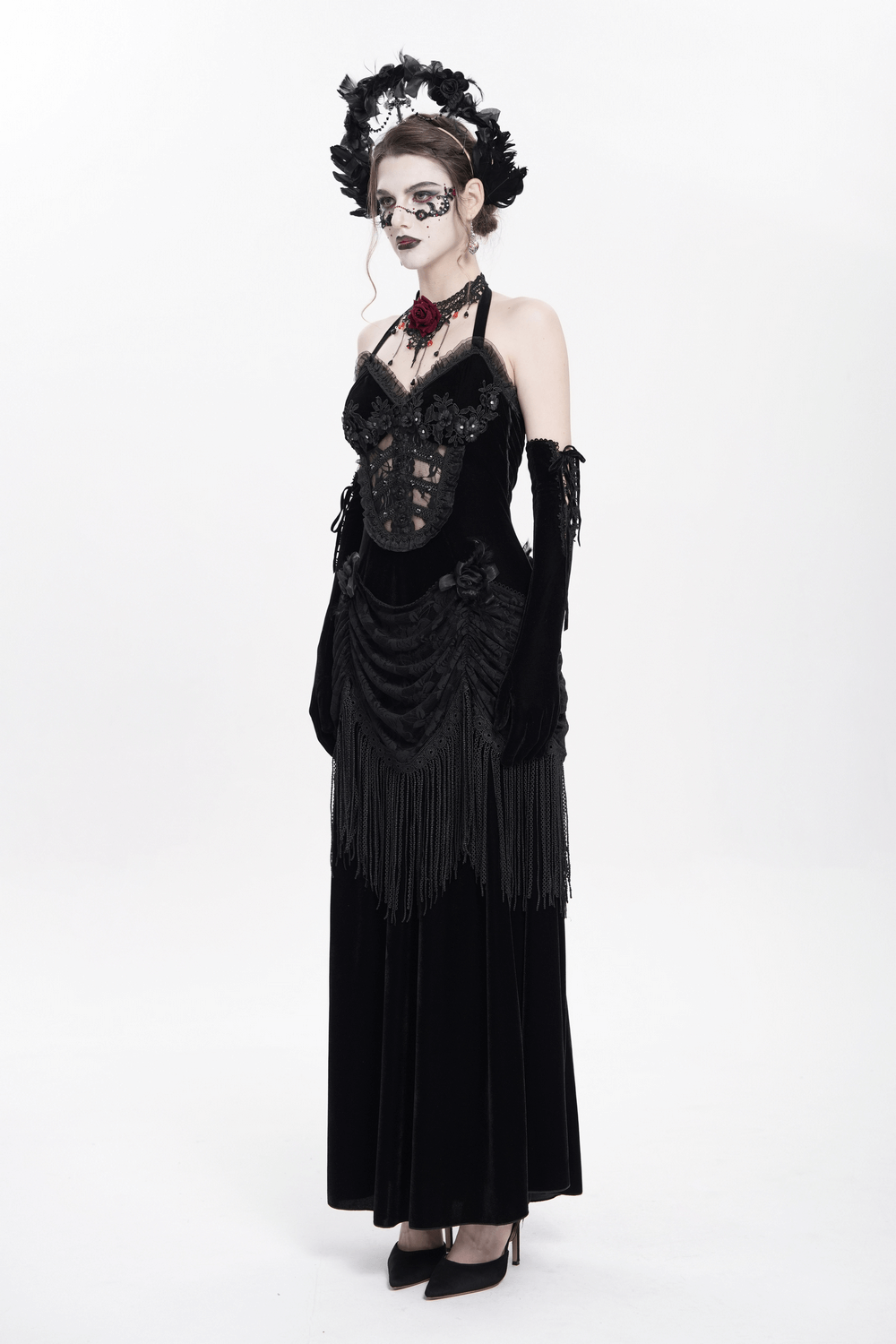 Gothic black velvet dress with lace and fringe, featuring a Victorian-inspired halter neckline and corset back.