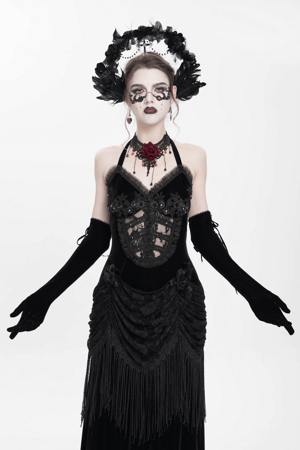 Gothic black velvet dress with lace, fringe details, and corset back, perfect for Victorian-inspired evening wear.