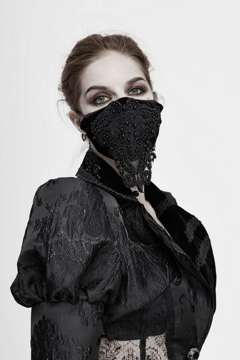 Gothic black velvet face mask with lace applique, styled model in elegant black outfit, perfect fashion accessory.