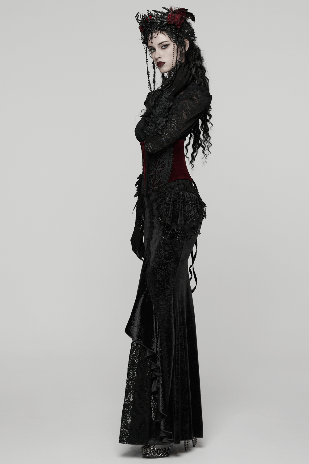 Gothic Black Velvet Fishtail Skirt with Lace Detail worn elegantly, showcasing its high-low hem and intricate lace accents.