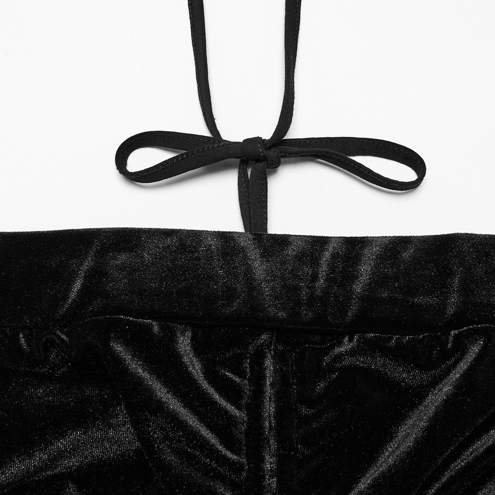 Close-up of ruched front and tie detail on gothic black velvet flared pants with mesh cutouts.