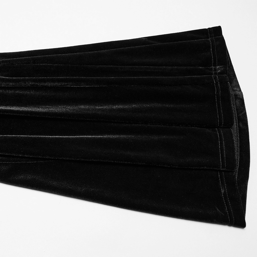 Close-up of gothic black velvet flared pants showcasing ruched front and textured fabric detailing.