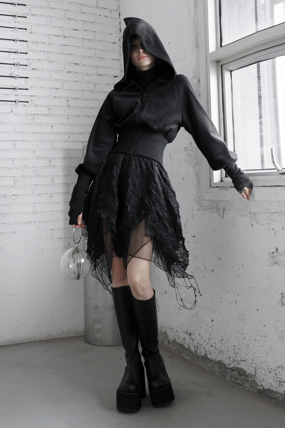 Gothic black velvet hoodie with pointed wizard hood and layered black skirt, accessorized with a glass orb.