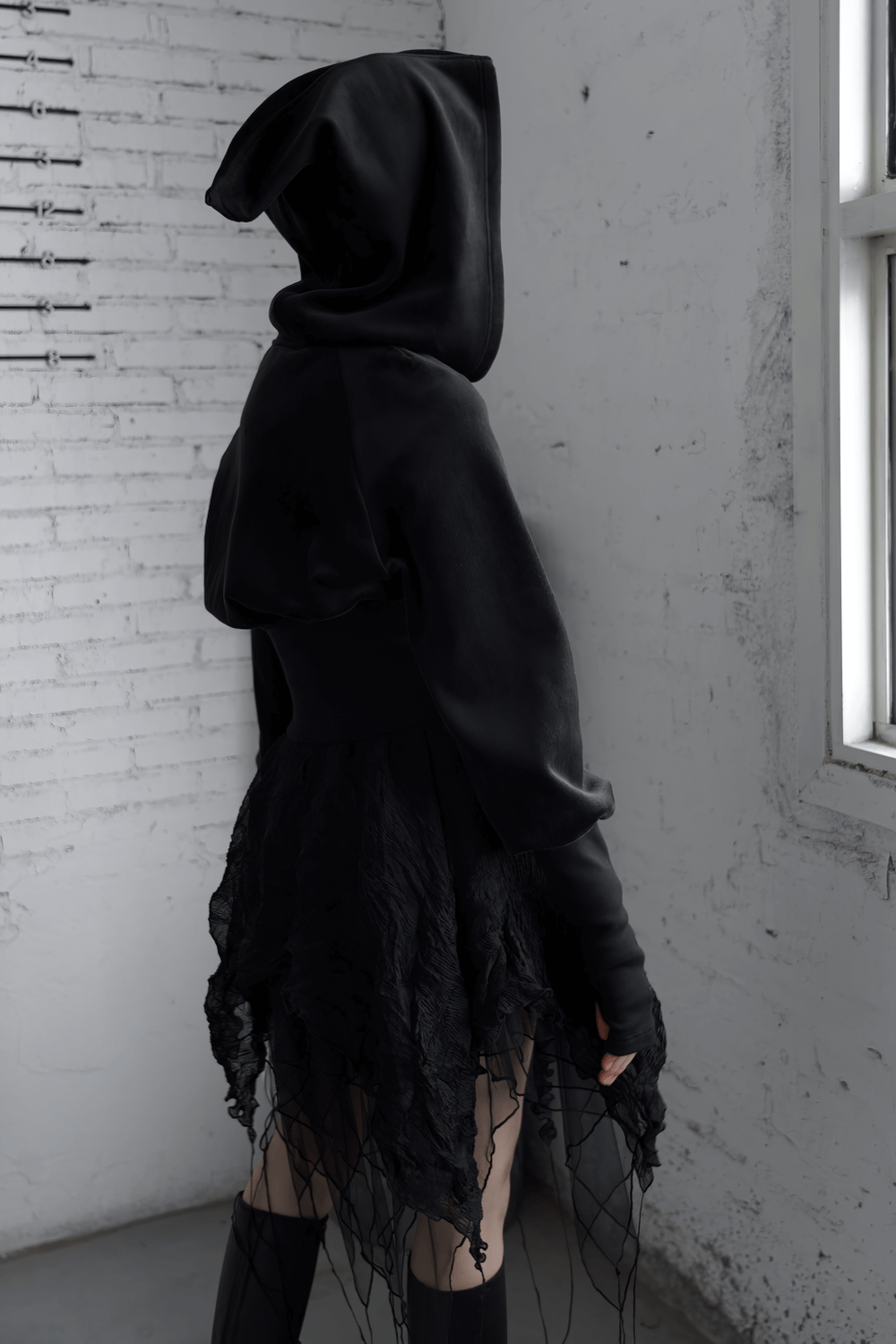 Gothic black velvet hoodie with pointed wizard hood and edgy, layered design showcasing unique style.