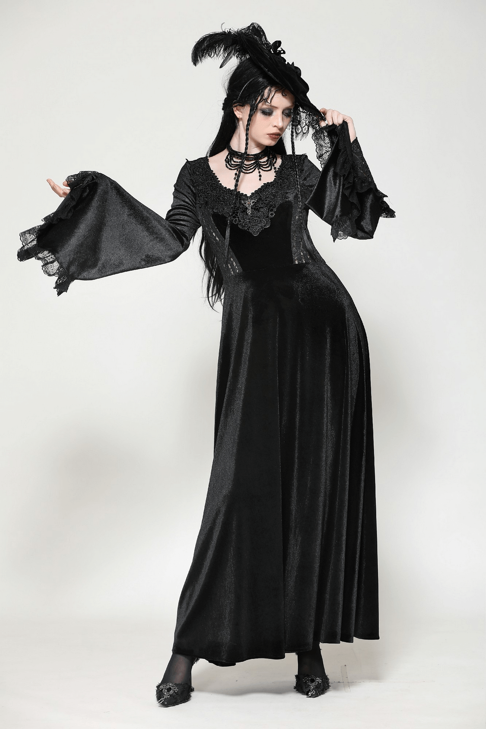 Elegant gothic black velvet dress with lace-up detail and dramatic bell sleeves, perfect for formal events or cosplay.