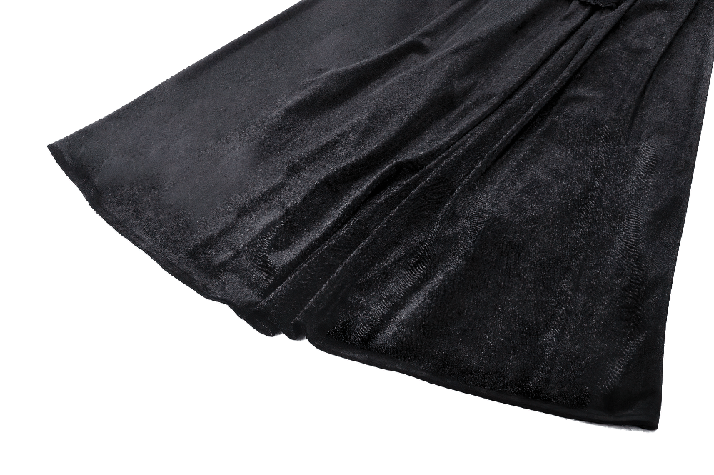 Elegant black velvet fabric of a gothic Renaissance dress, showcasing its luxurious sheen and flowing design.