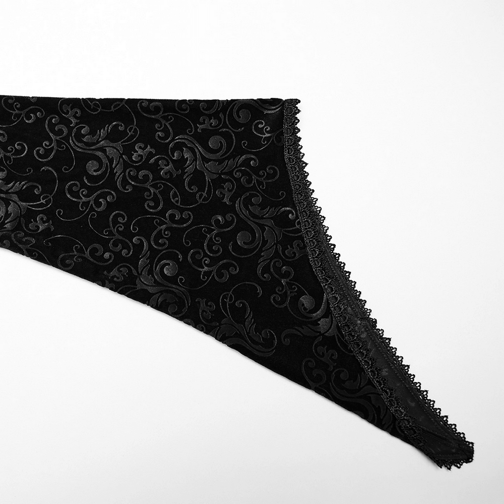 Gothic black velvet fabric with embossed floral details and intricate lace trim.