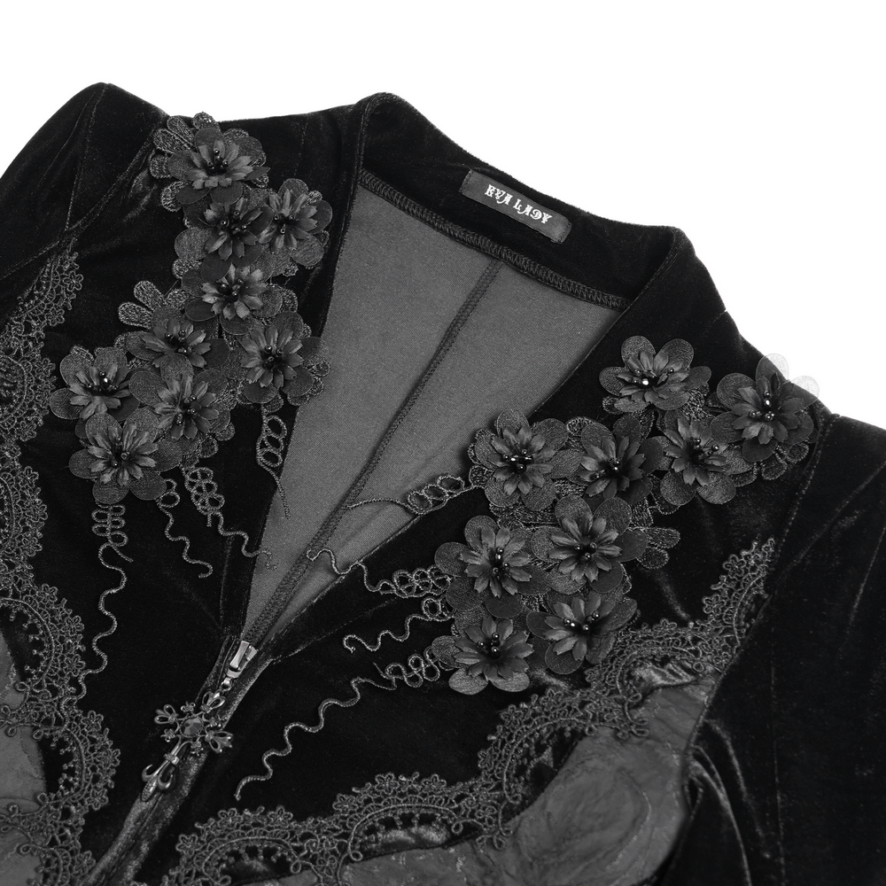 Close-up of Gothic black velvet dress with lace, floral embroidery, and sleek zipper detailing.