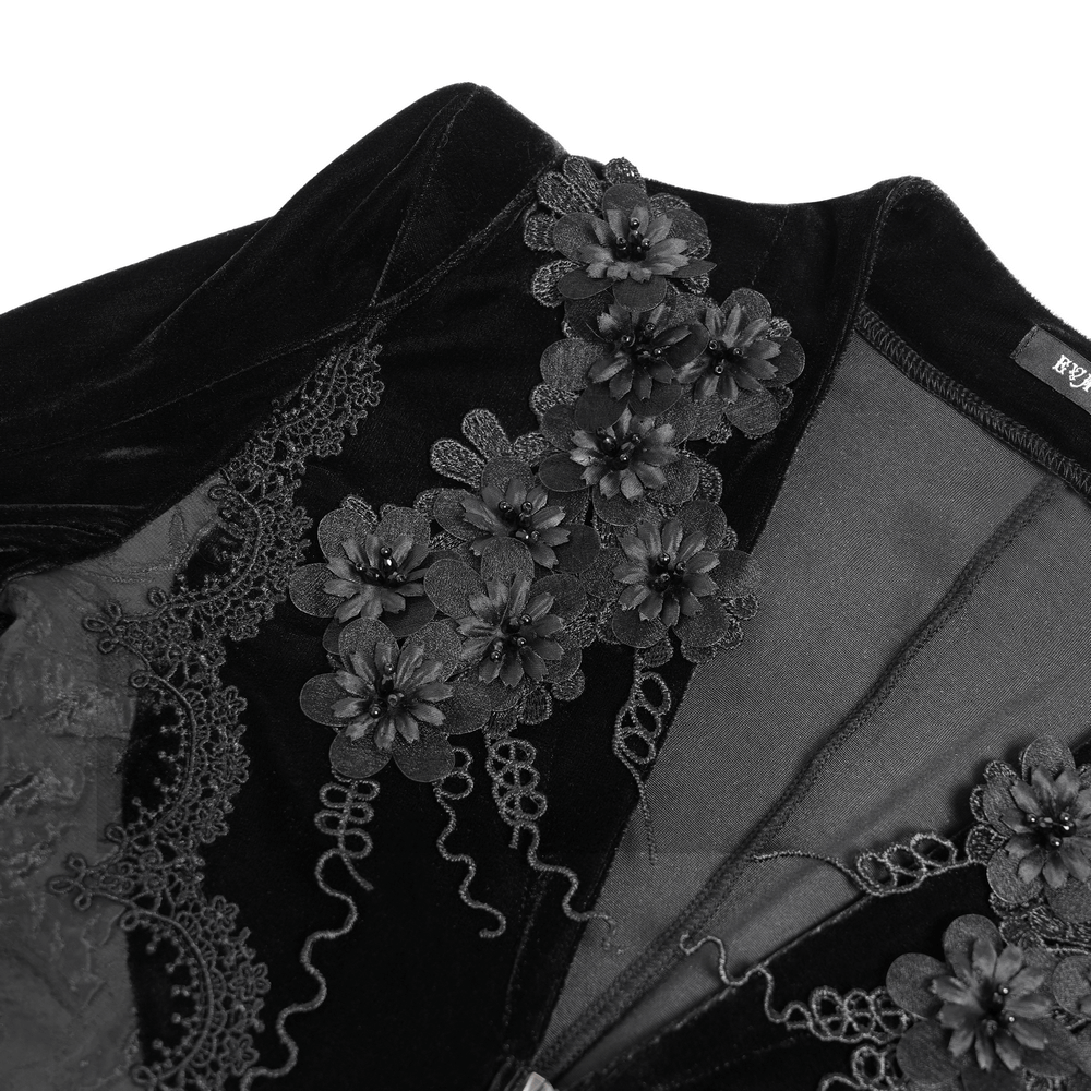 Close-up of the Gothic black velvet dress featuring intricate lace and floral embroidery details.