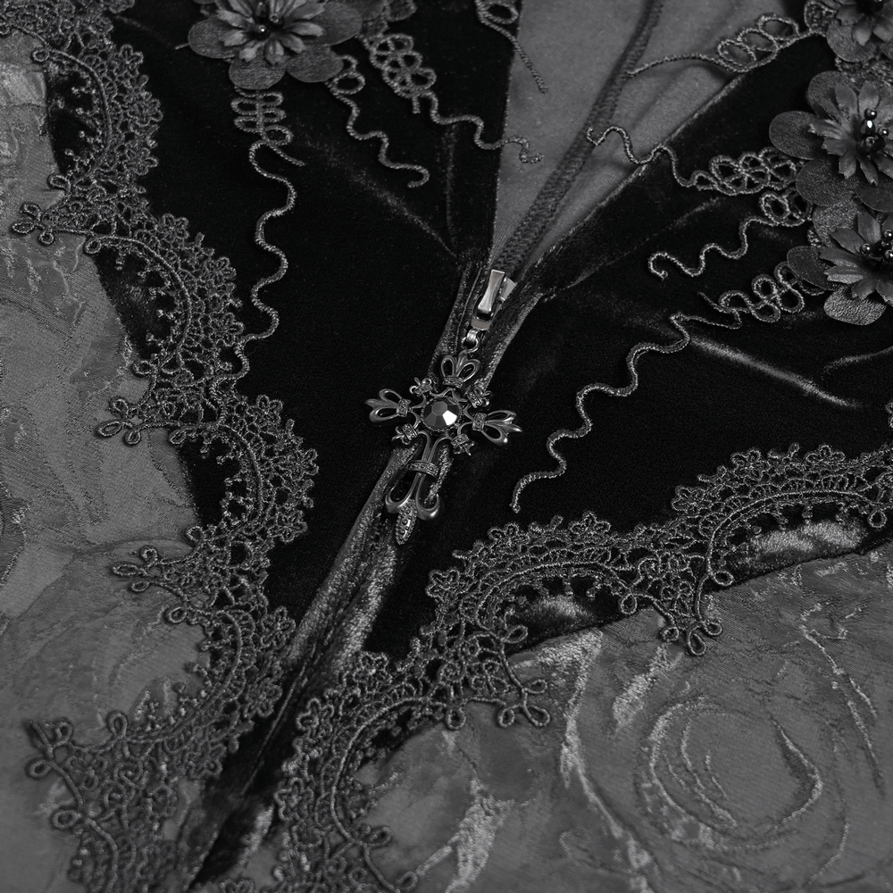 Close-up of black velvet dress detailing with lace embroidery, flared sleeves, and elegant zipper embellishment.