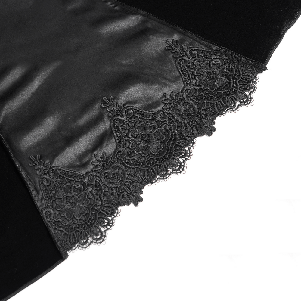 Close-up of black lace detailing on gothic velvet dress, showcasing intricate patterns and elegant design.