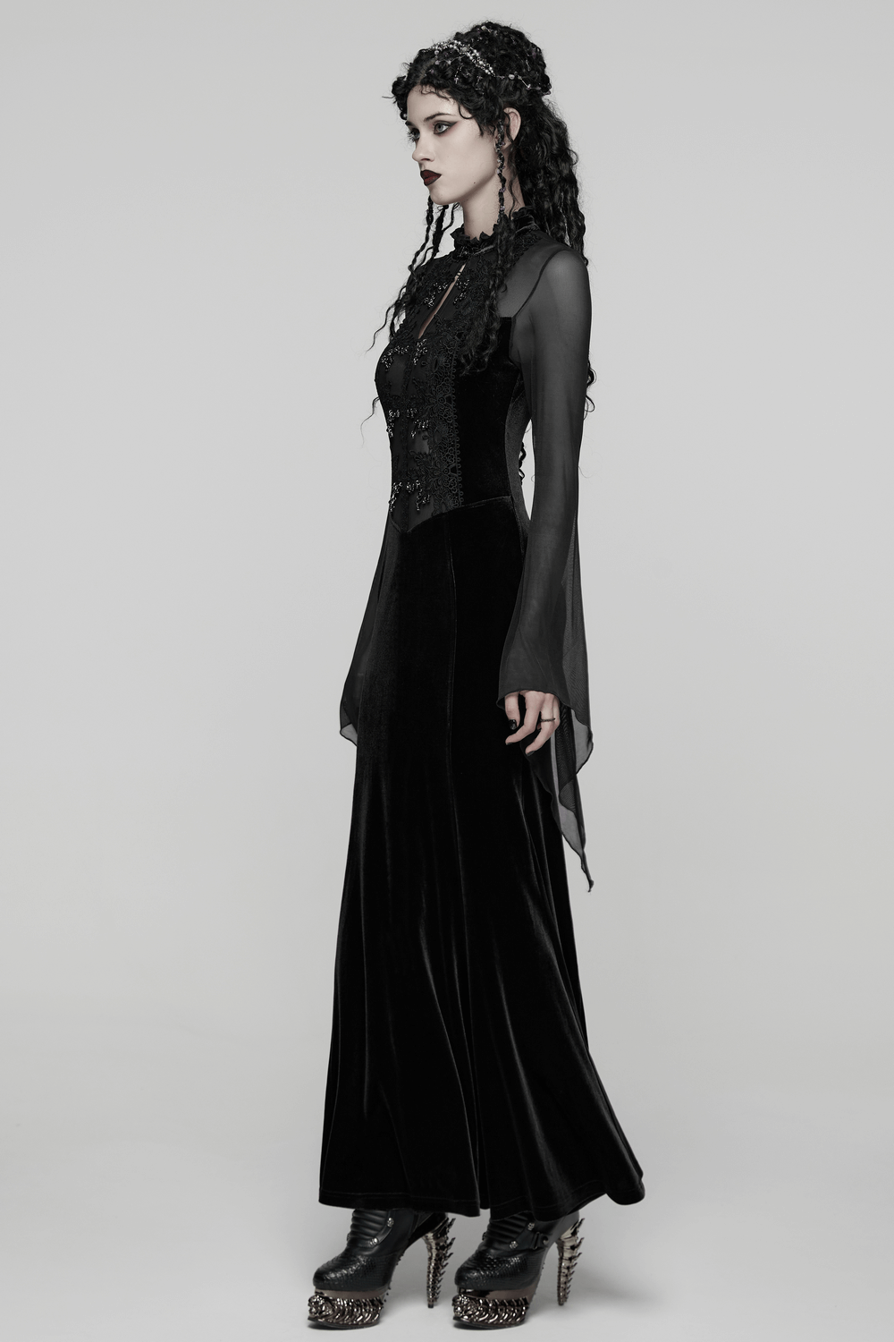 Gothic Black Velvet Maxi Dress with Lace and Mesh on model showcasing sheer sleeves and crystal trim.