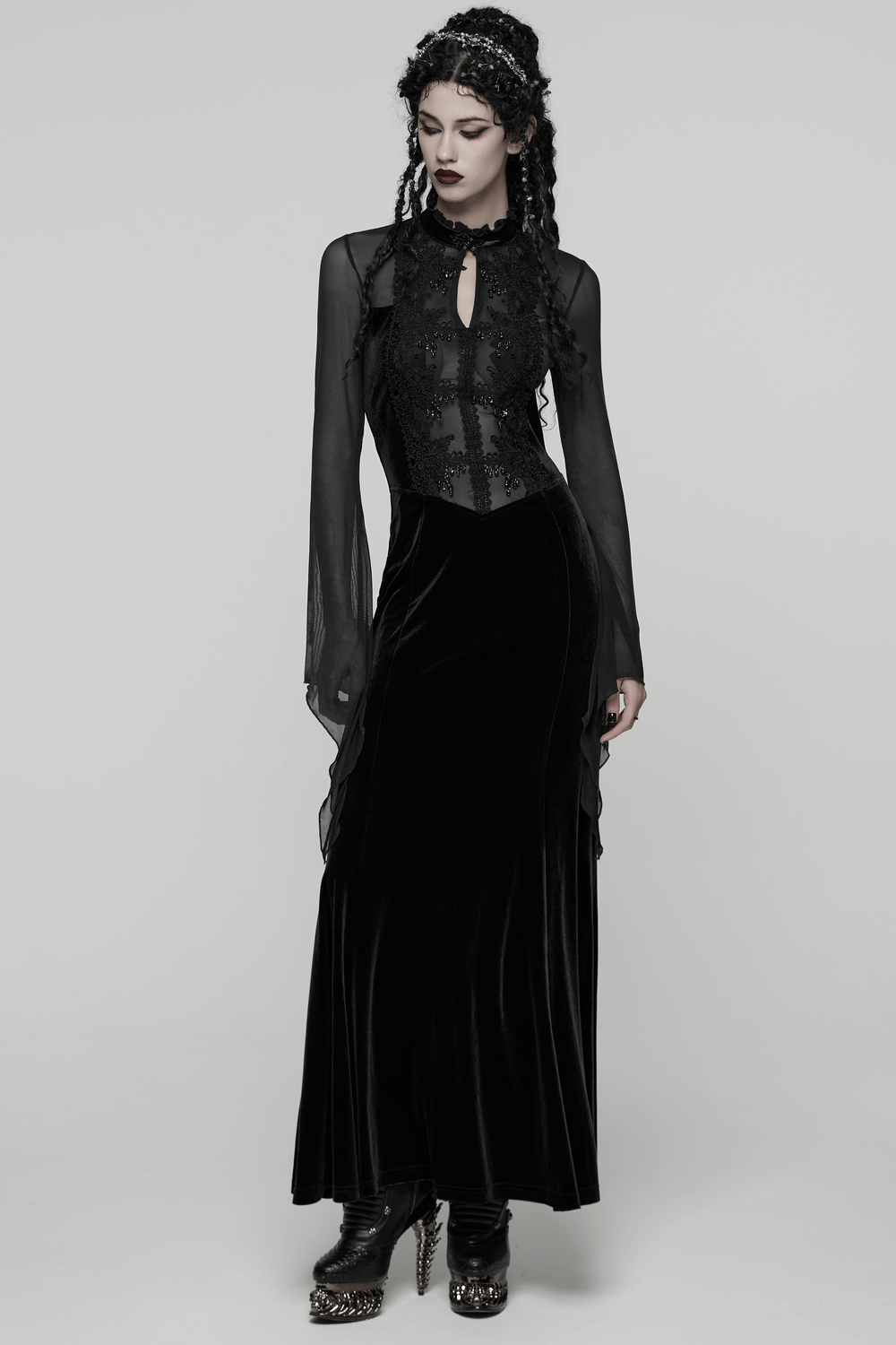 Gothic Black Velvet Maxi Dress with Lace and Mesh on a model showcasing its dramatic silhouette and vintage charm.