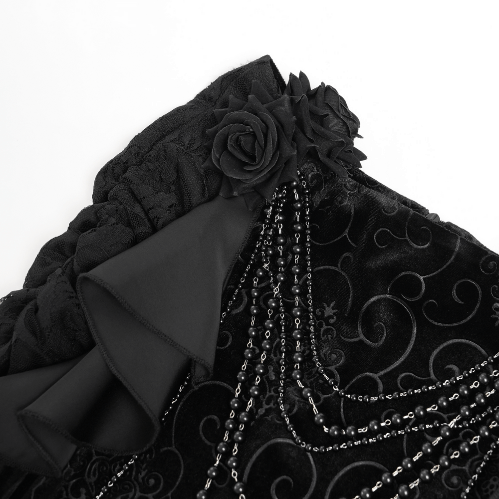 Gothic black velvet maxi skirt detail featuring cascading ruffles, floral accents, and draped chains for a dramatic look.