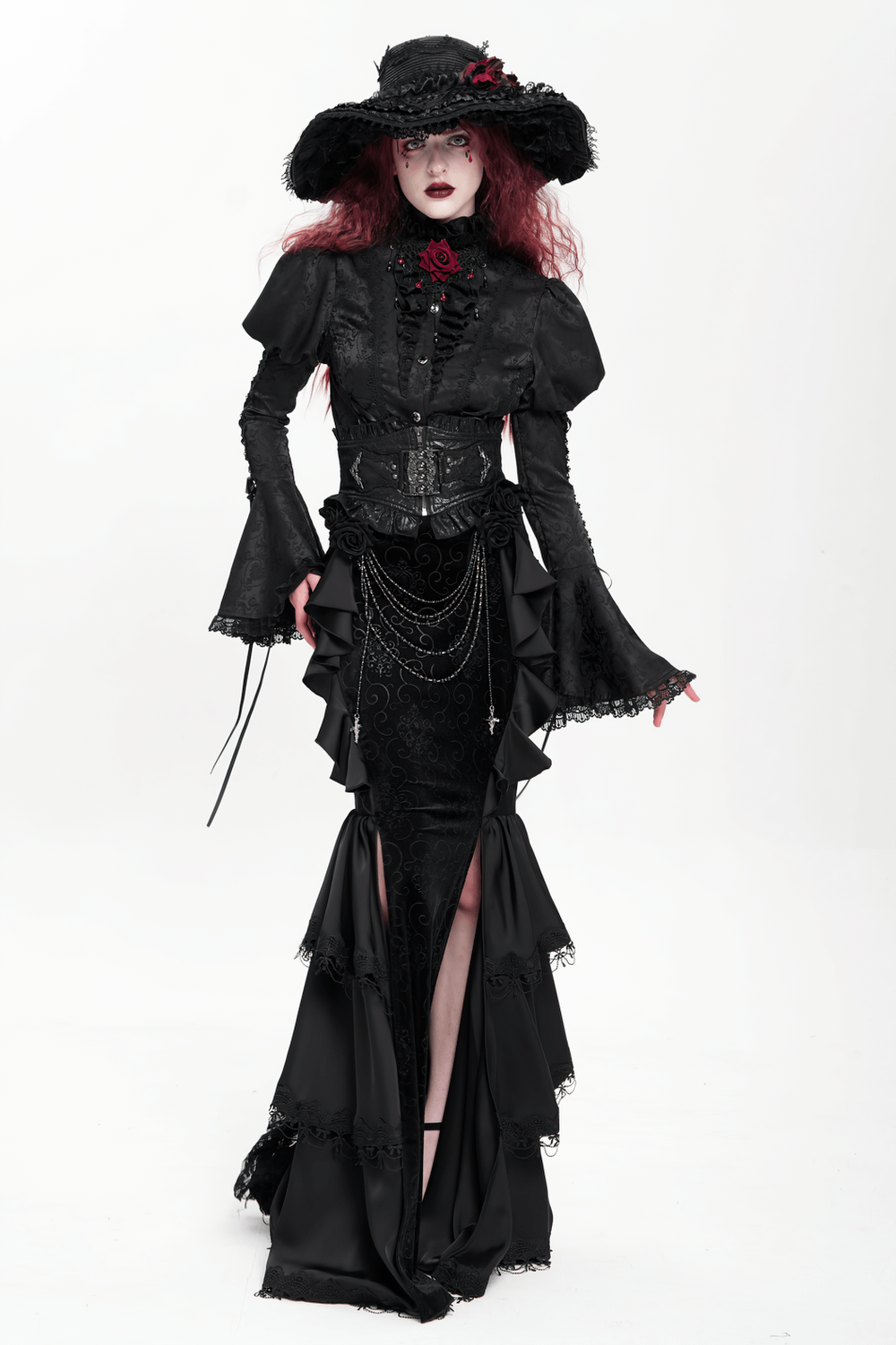 Gothic black velvet maxi skirt with ruffles and chains, paired with an elegant black corset and wide-brim hat, showcasing dark elegance.