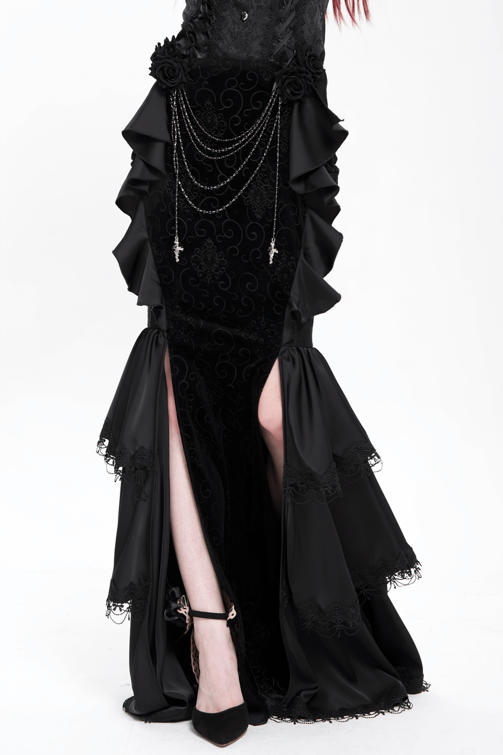 Elegant gothic black velvet maxi skirt with ruffles, chains, and lace trim showcasing a dramatic silhouette.