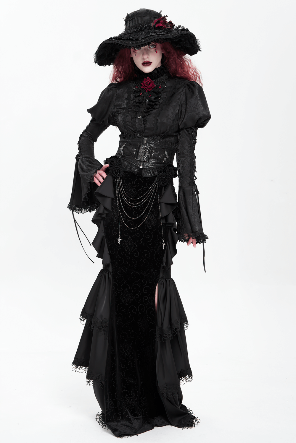 Gothic black velvet maxi skirt with ruffles, chains, and lace, styled with an elegant black corset and hat.