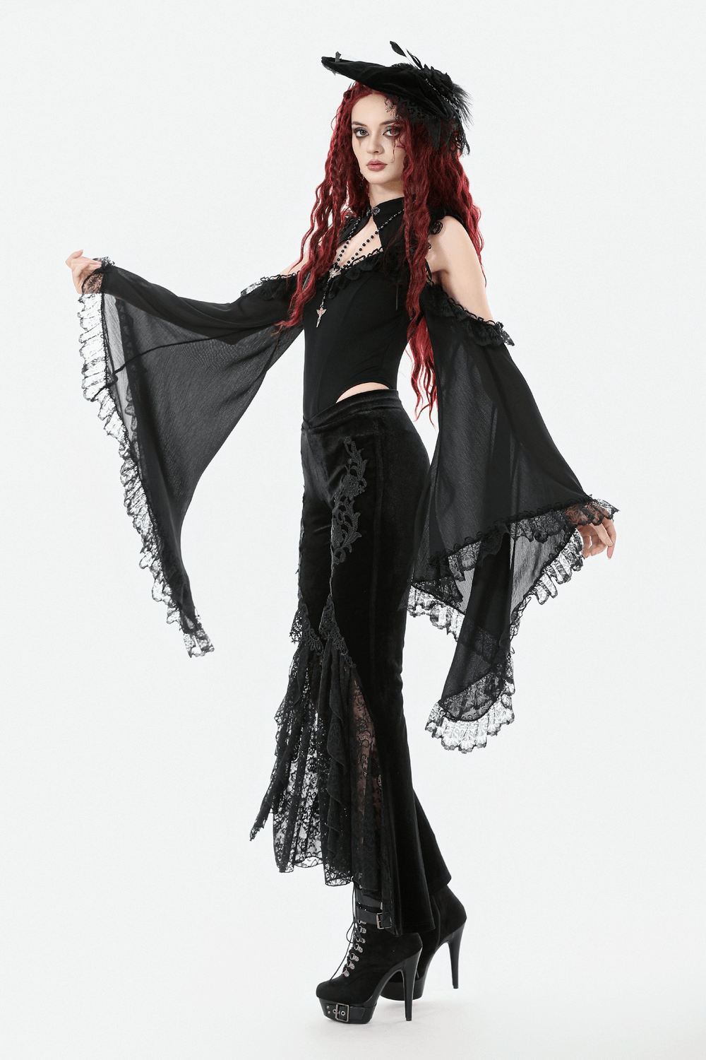 Gothic Black Velvet Pants with Lace Ruffle Panels styled with a black flowing cape and dramatic accessories.