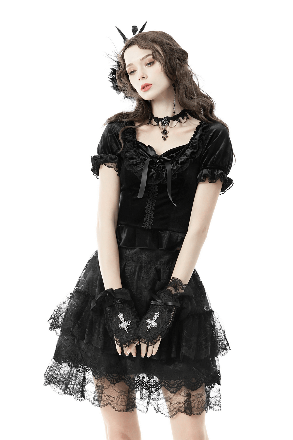 Gothic black velvet puff sleeve top with lace-up detail and frill, paired with a matching lace skirt and gloves.