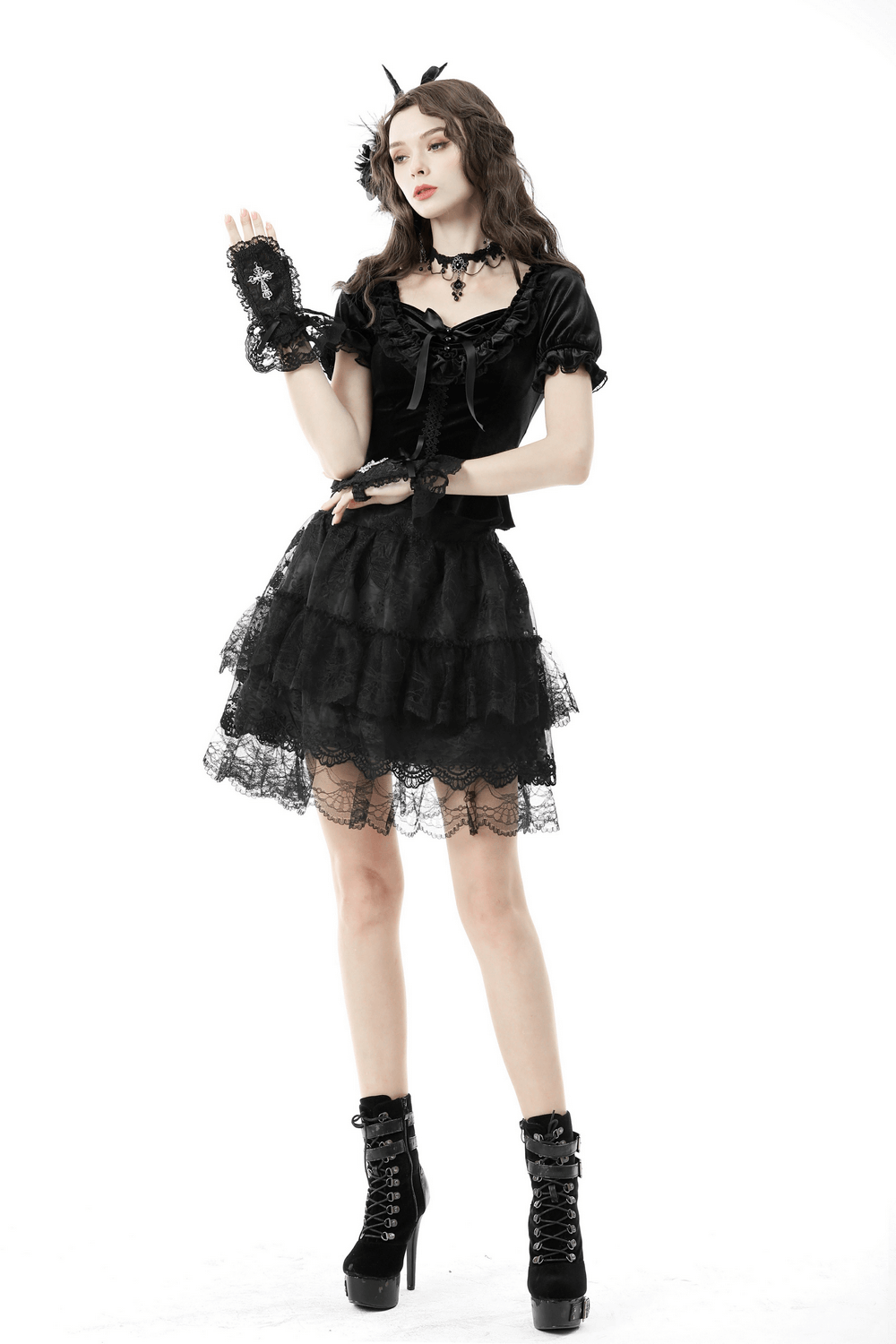 Gothic black velvet puff sleeved top paired with a layered lace skirt and stylish knee-high boots.