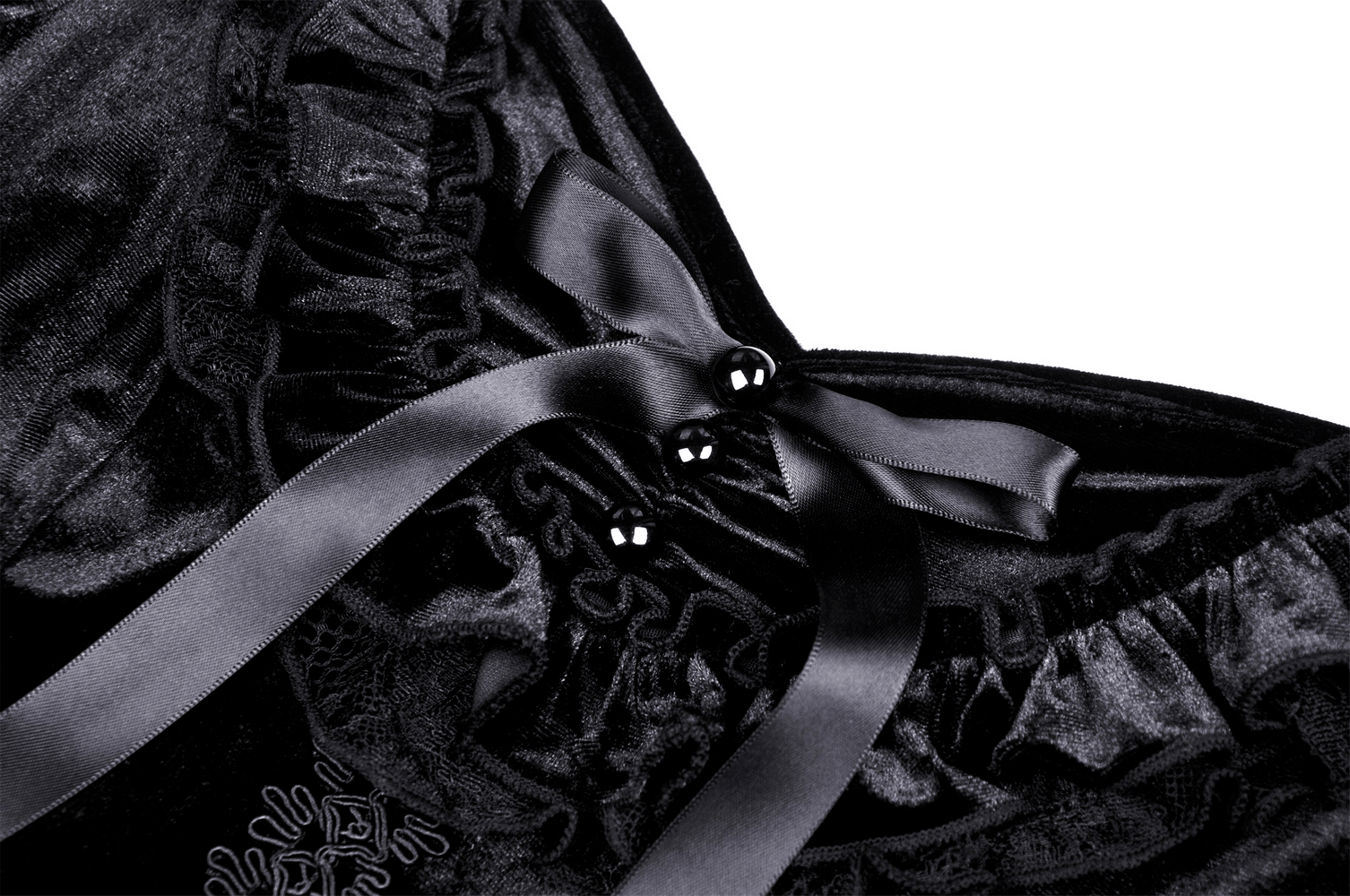 Close-up of gothic black velvet top featuring satin ribbons and frill details for a romantic, edgy style.