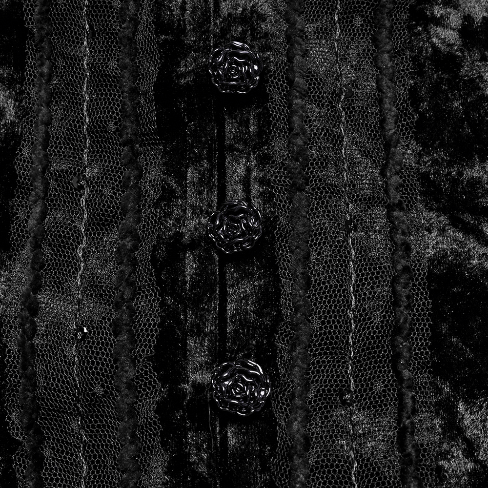 Close-up of black velvet shirt with lace and rose buckles, showcasing gothic style and vintage elegance.