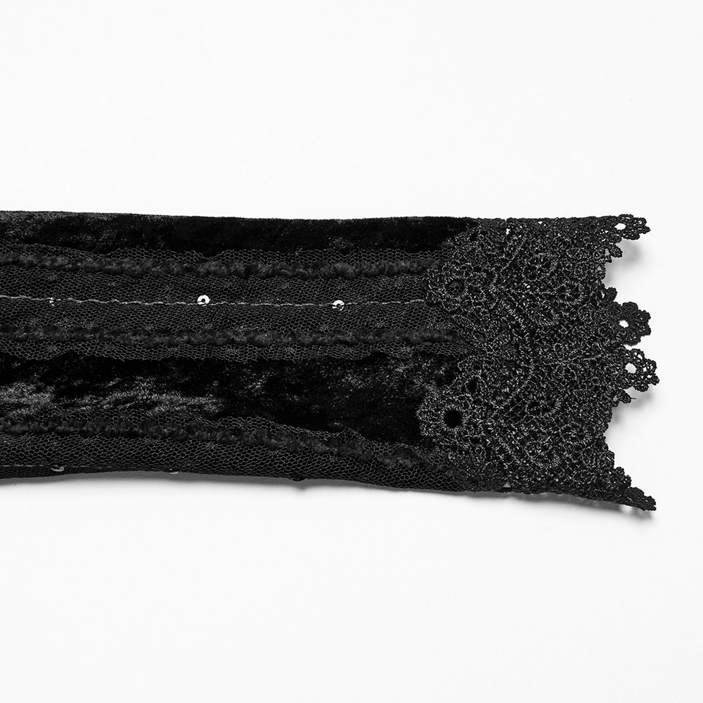 Close-up of black velvet fabric with intricate lace trim, ideal for gothic fashion or as a vintage embellishment.