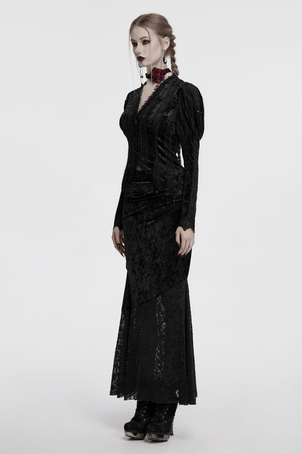 Gothic black velvet shirt with gigot sleeves and lace details, worn by a model in a stylish, elegant pose.