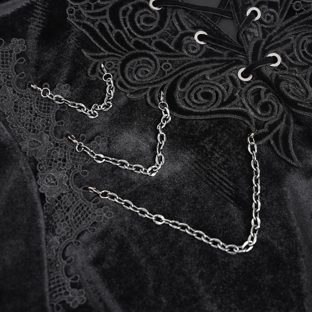 Close-up of gothic black velvet shirt featuring intricate lace and delicate chain details for a Victorian-inspired look.