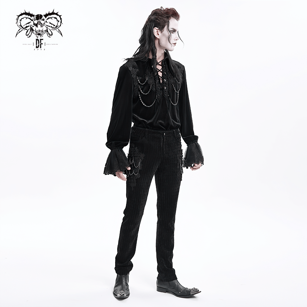 Gothic black velvet slim fit pants with chain embellishments, model showcasing a bold gothic fashion look.