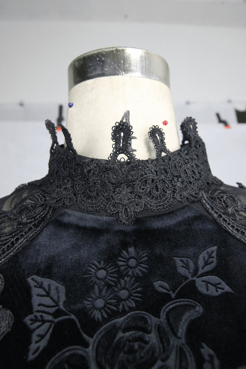 Close-up of the gothic black velvet top with intricate lace collar and floral embroidery details.
