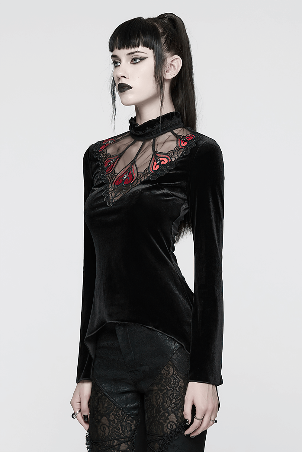 Gothic Black Velvet Top with Lace and Red Heart Detail worn by a model, showcasing its unique romantic design.
